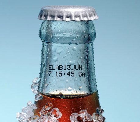 Continuous Inkjet coding on a glass beverage bottle showing production and batch information.